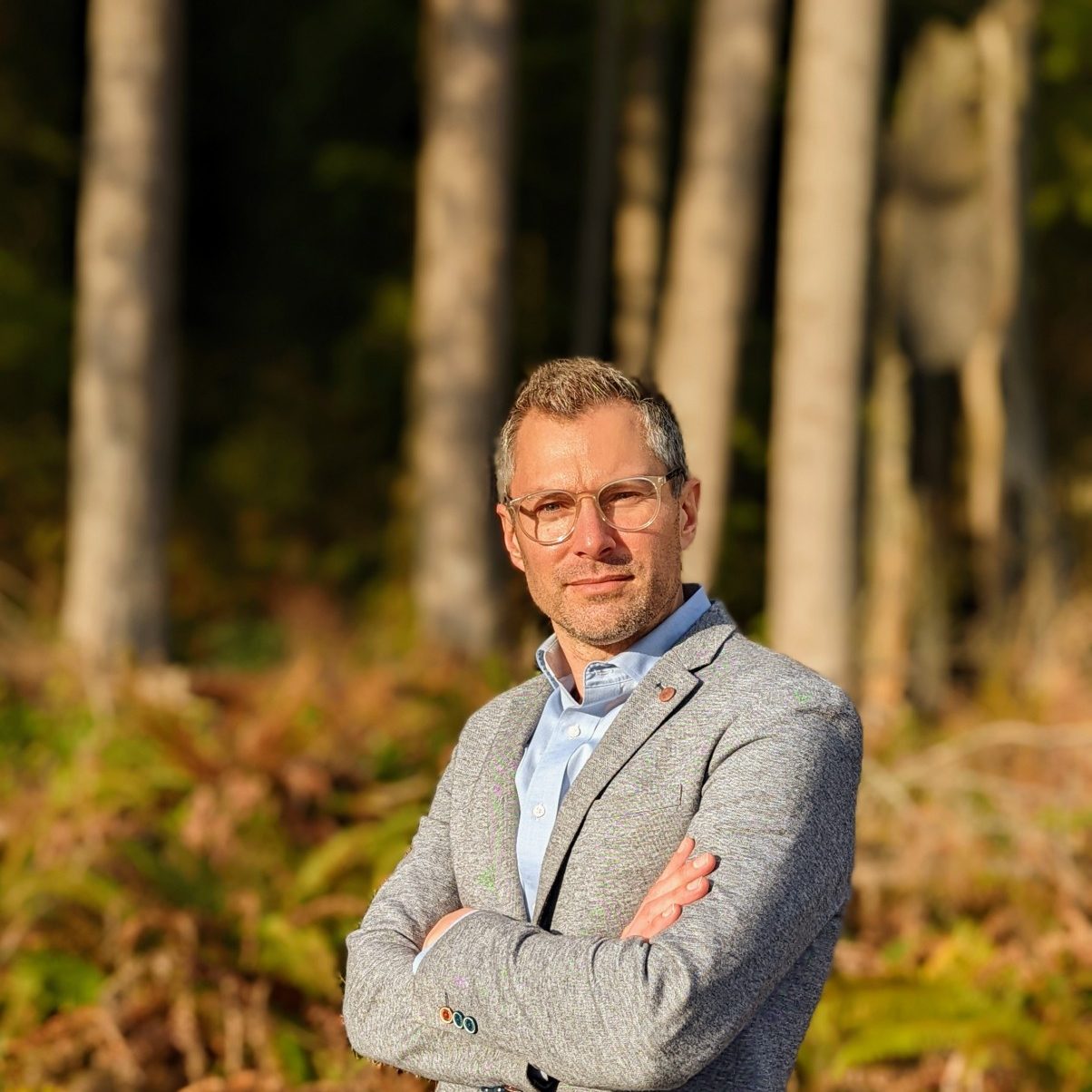 Portrait of Brad Doff with a suit and background in the woods